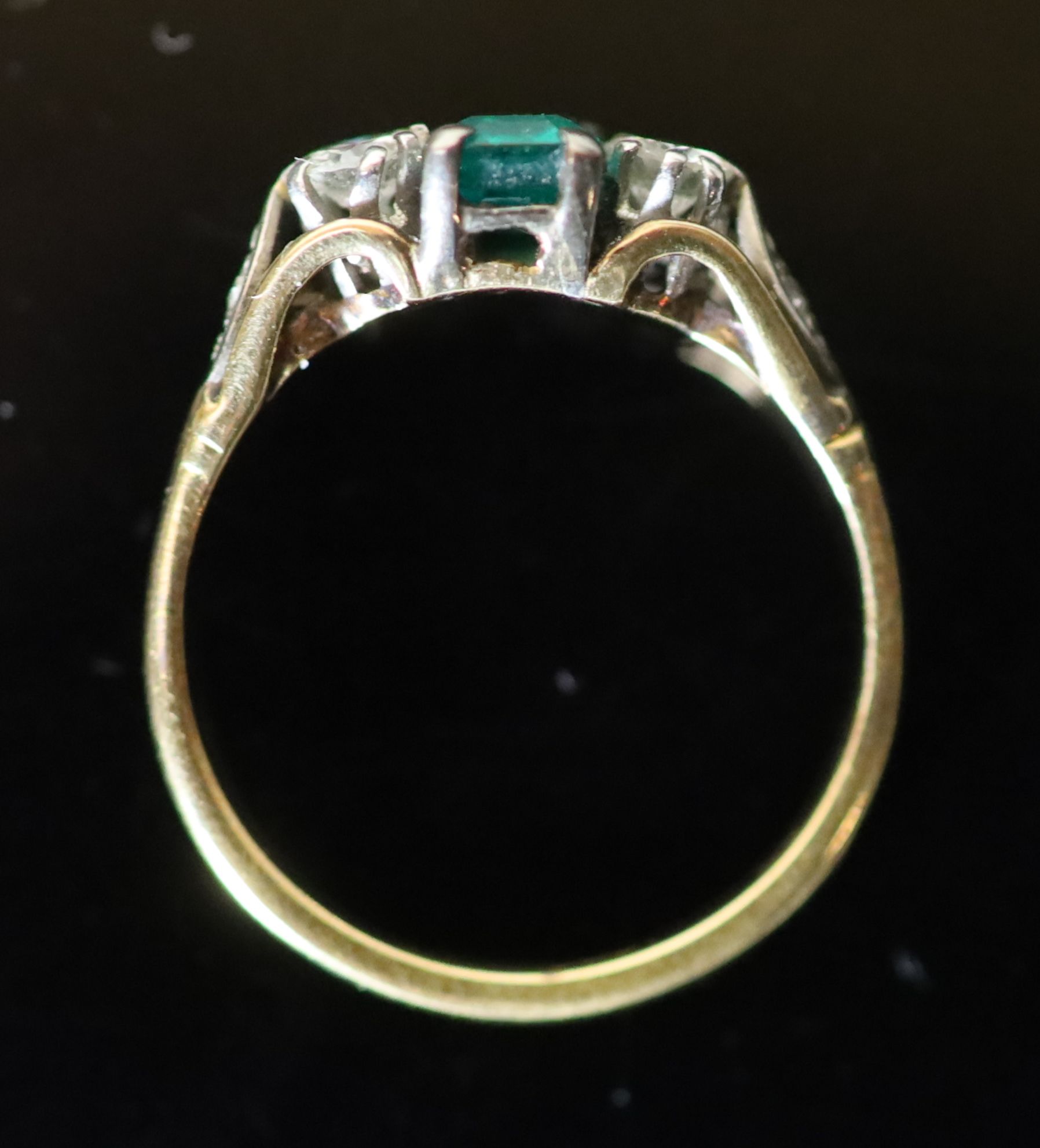 An 18ct gold, emerald and diamond set three stone ring,
